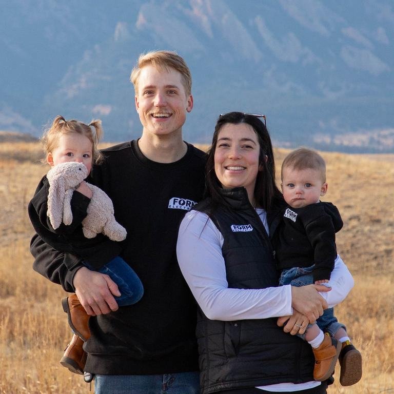 Adam with his family in front of the Rocky Mountains